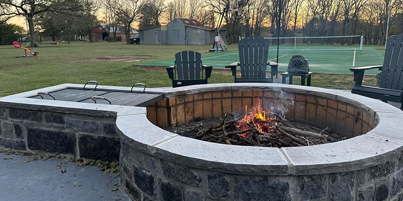 Stone wood-burning fire pit with a real fire